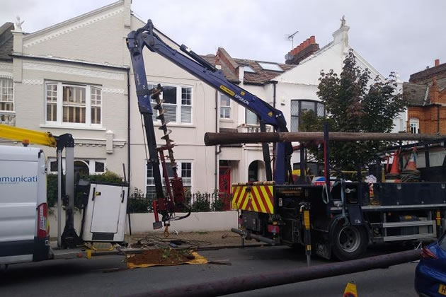 Heavy machinery being operated next to an unguarded pavement