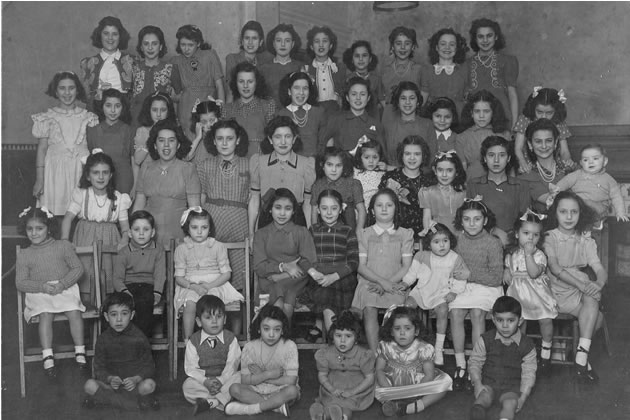 Gibraltar children at Whiteland’s with Joe Gingell sitting on floor, first from the right