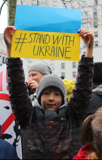 Child with ‘stand with Ukraine’ banner
