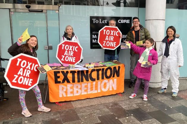 Young Extinction Rebellion volunteers handed out leaflets 