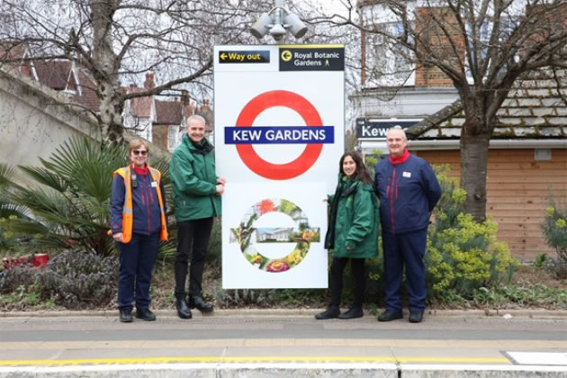 Kew Gardens station staff and Kew Visitor Hosts with the specially designed roundel to mark this partnership