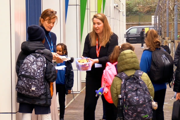 Kate Stock (centre)and Clare Mitchell (left) handing out bagels to children 