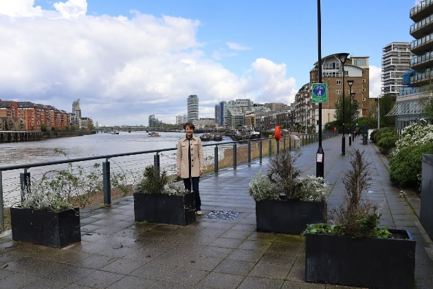 Councillor Jenny Yates next to existing planter box arrangements designed to slow bicycle speeds